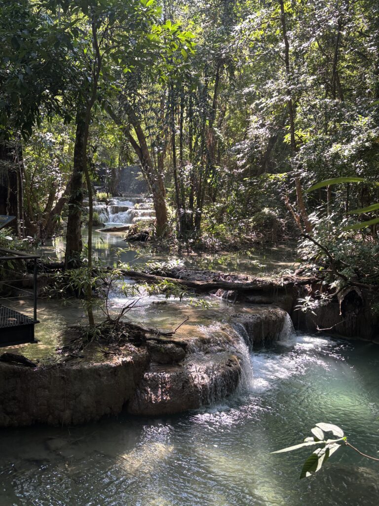 Erawan Waterfalls surrounded by greenery in Kanchanaburi, Thailand.