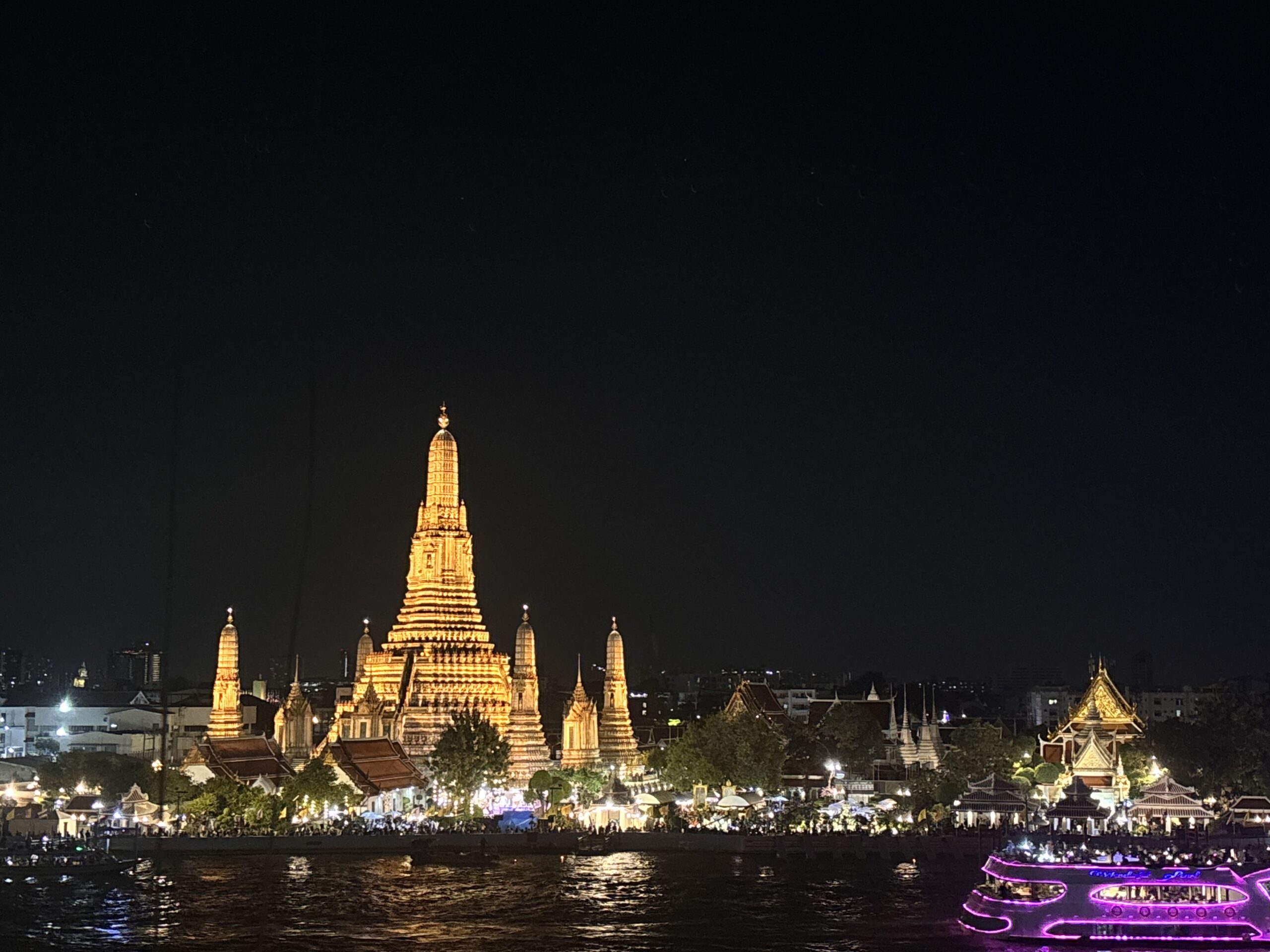 Wat Arun temple in Bangkok with colorful sunset sky